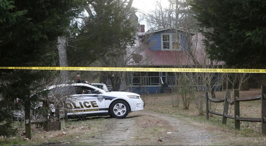 Police found one victim's body behind this vacant home